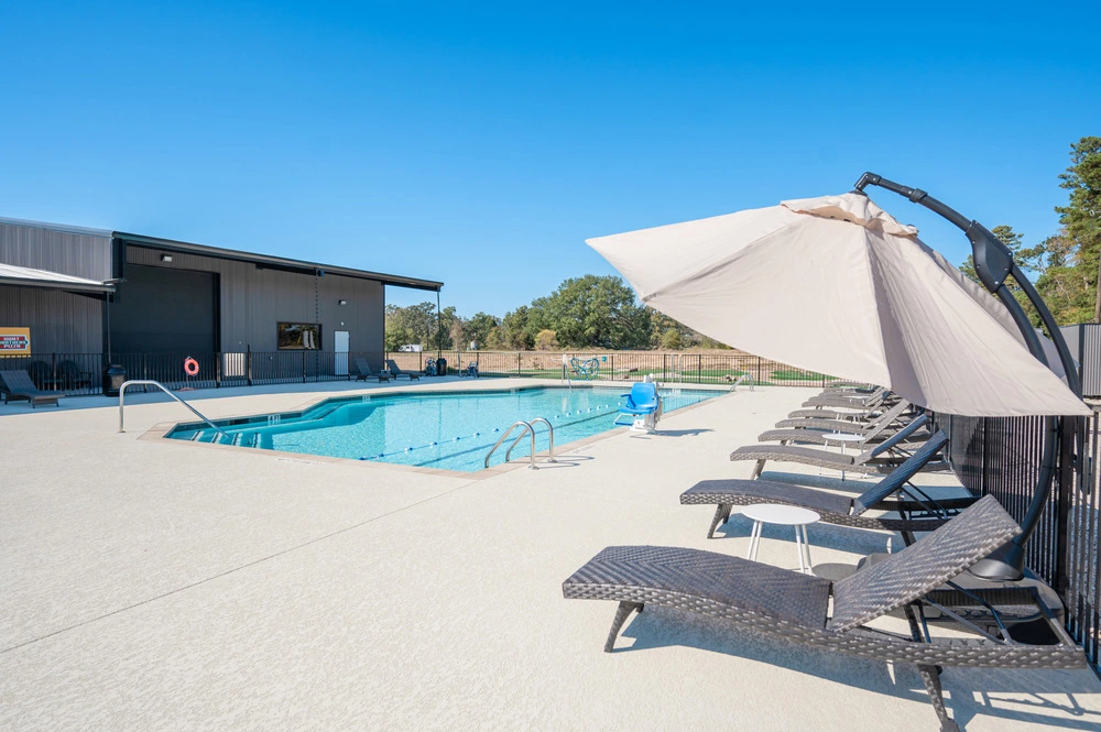 outdoor pool and lounge chairs at Twin Lakes Resort in Mt Pleasant