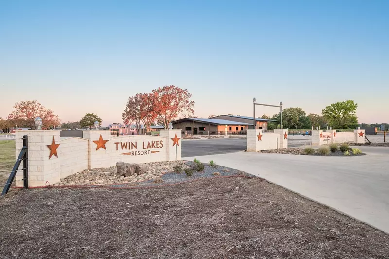 Twin Lakes Resort sign at entrance with fall foliage in background